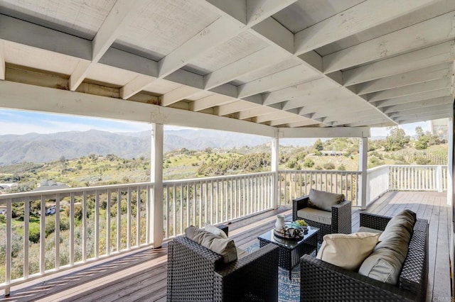 deck with a mountain view and an outdoor living space