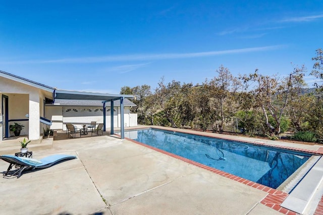 view of swimming pool featuring a patio area