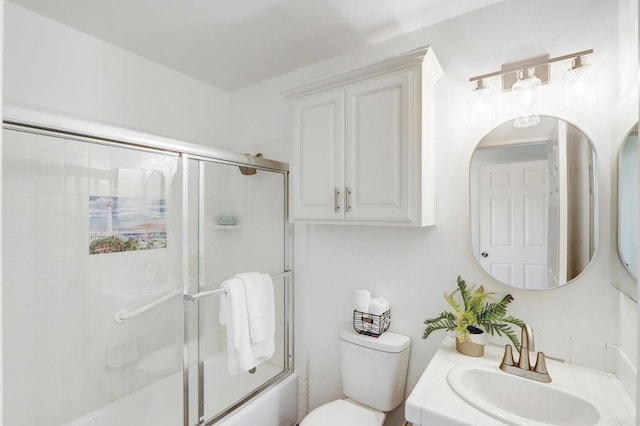 full bathroom with toilet, vanity, and combined bath / shower with glass door