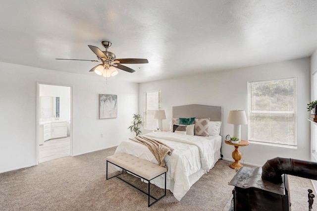 carpeted bedroom featuring ceiling fan and connected bathroom