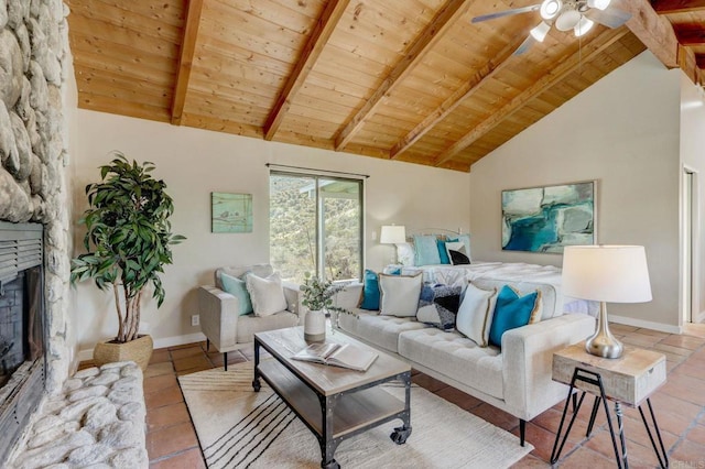 tiled living room featuring ceiling fan, beam ceiling, a stone fireplace, high vaulted ceiling, and wooden ceiling