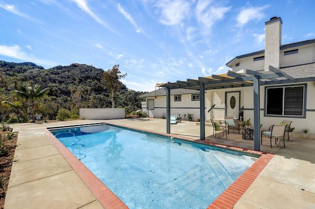 view of swimming pool with a patio and a pergola