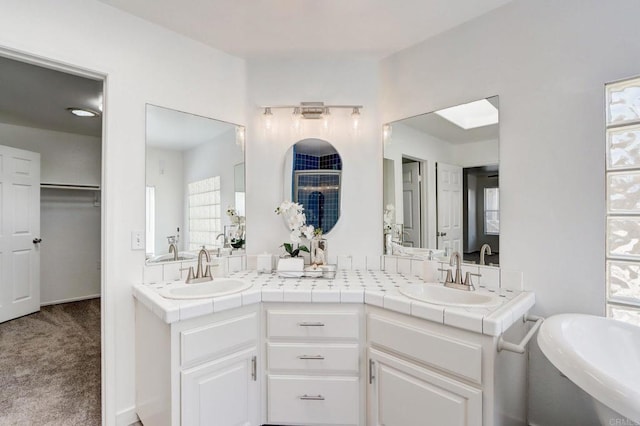 bathroom with vanity and a bathing tub