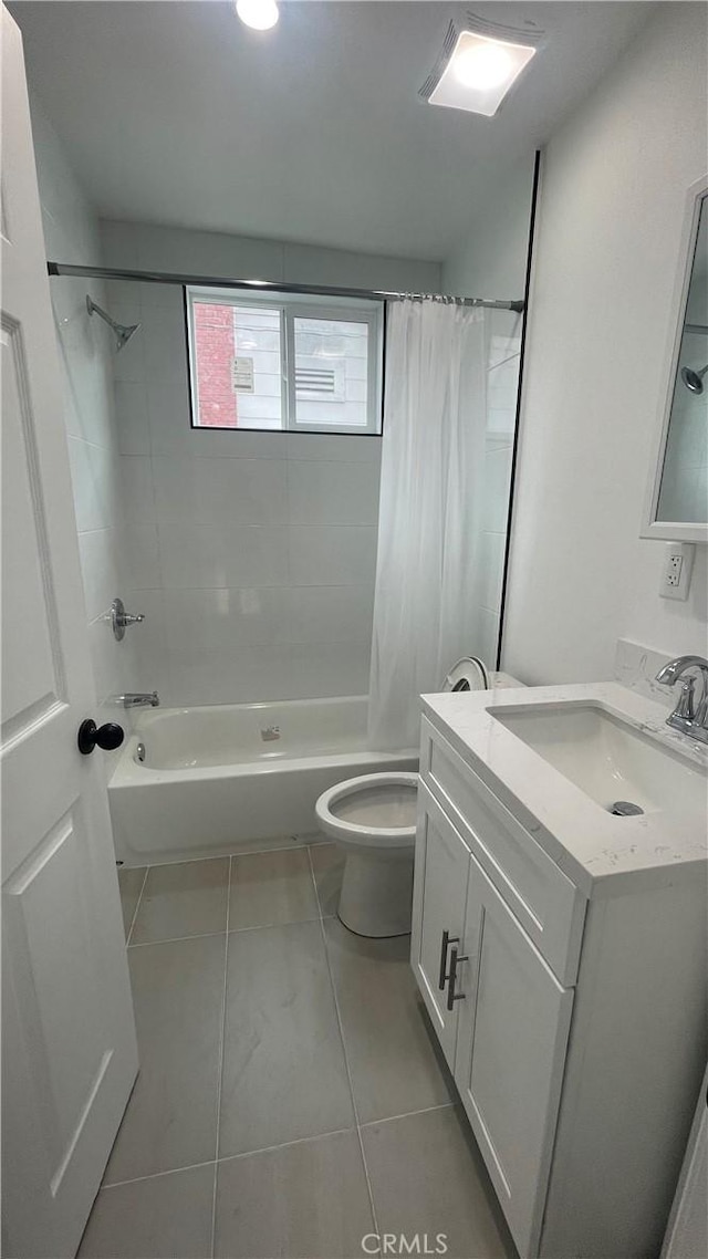 full bathroom featuring tile patterned floors, vanity, toilet, and shower / bath combo with shower curtain