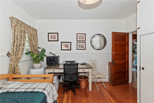 bedroom with hardwood / wood-style flooring