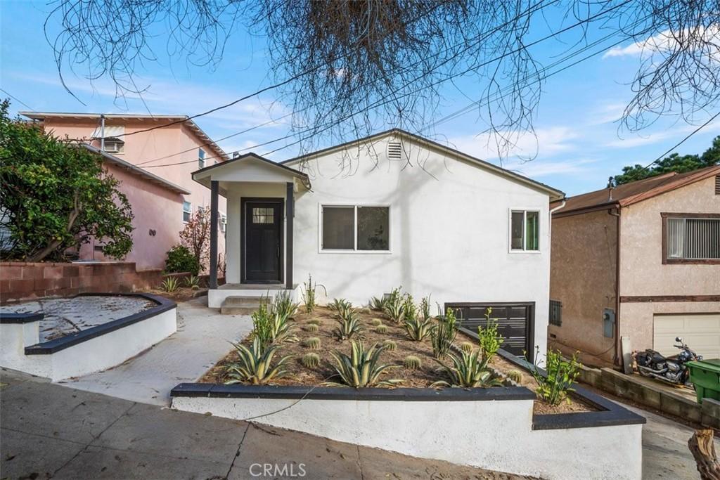 724 Onarga Ave, Los Angeles, CA 90042 - view of front facade featuring stucco siding and an attached garage