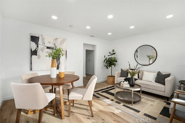 dining area with light hardwood / wood-style flooring