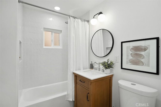 full bathroom with vanity, shower / tub combo, and toilet