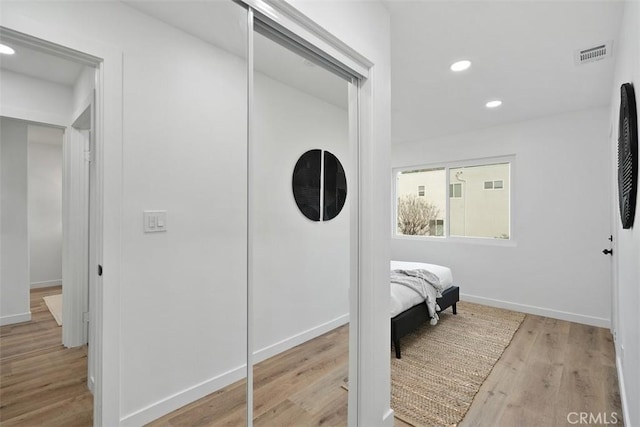 bedroom featuring a closet and light hardwood / wood-style flooring