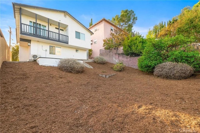 exterior space with ac unit and a balcony