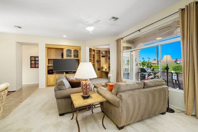 living room with light carpet and ceiling fan