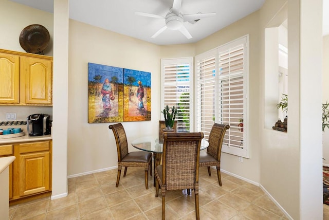 tiled dining area featuring ceiling fan