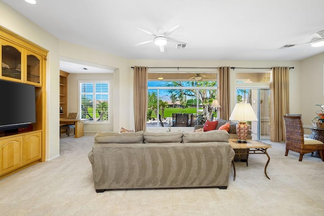 living room with ceiling fan and light colored carpet