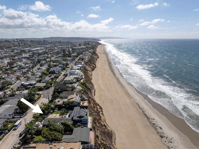 birds eye view of property featuring a view of the beach and a water view