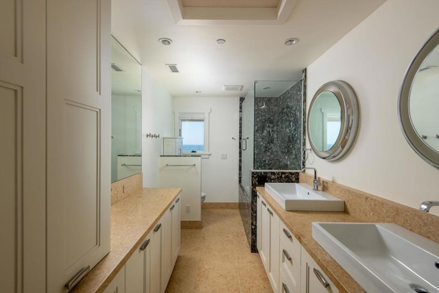 bathroom featuring vanity, toilet, tile patterned floors, and a tile shower