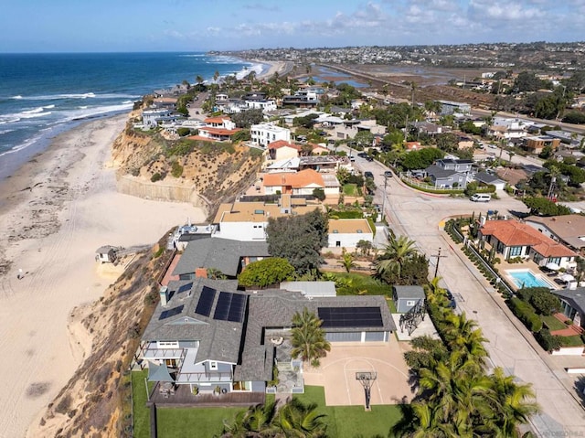 aerial view with a water view and a beach view