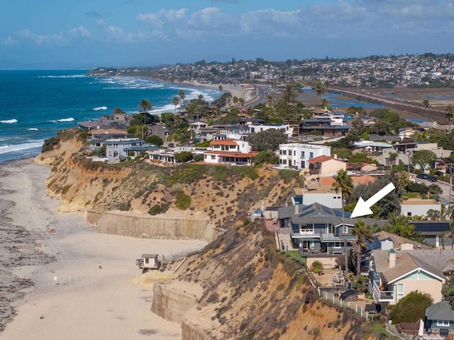 birds eye view of property featuring a view of the beach and a water view