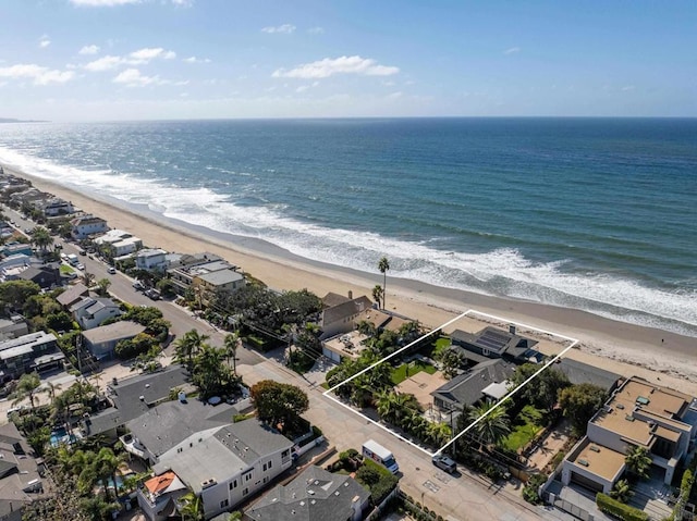 drone / aerial view with a water view and a beach view