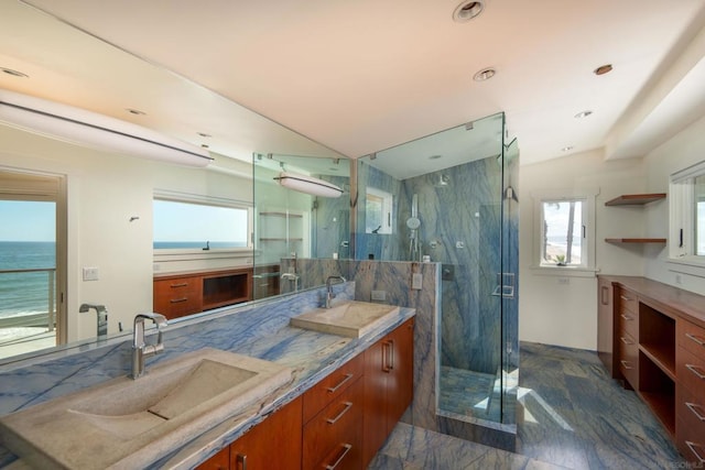 bathroom featuring a water view, walk in shower, and vanity