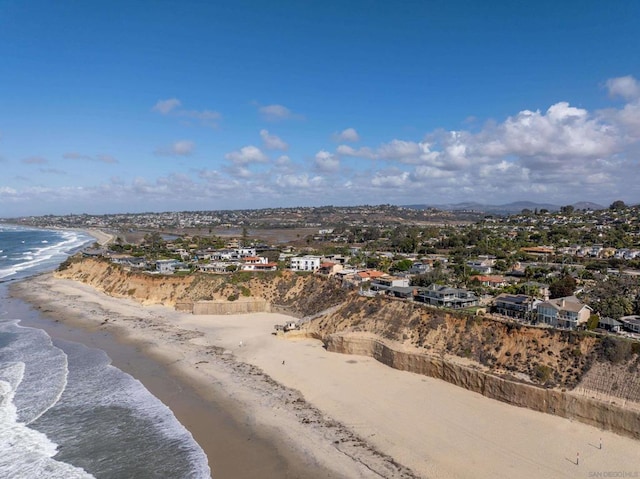 birds eye view of property featuring a water view and a view of the beach