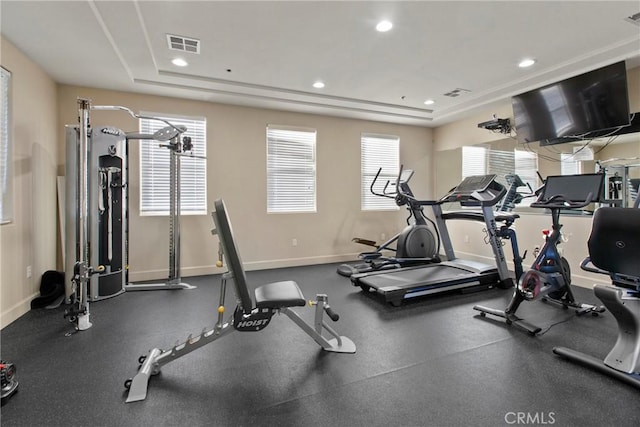 workout area featuring a raised ceiling