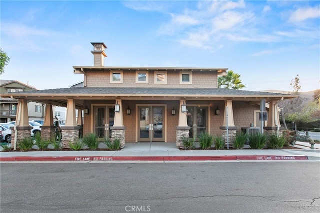 view of front of house featuring french doors and cooling unit