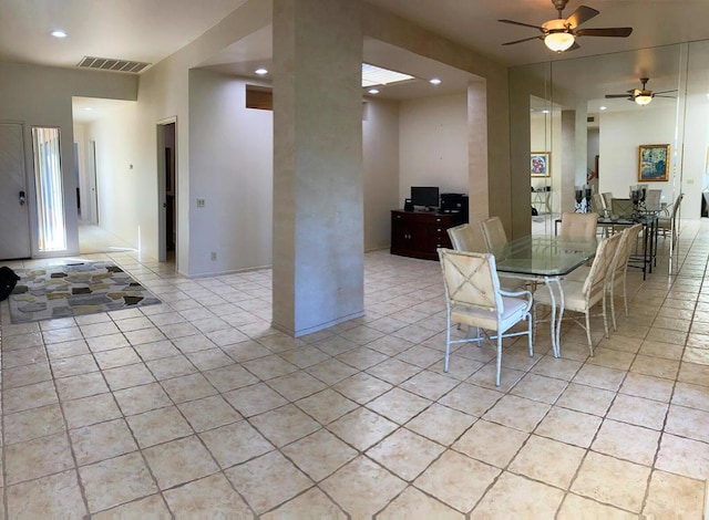 tiled dining room featuring ceiling fan