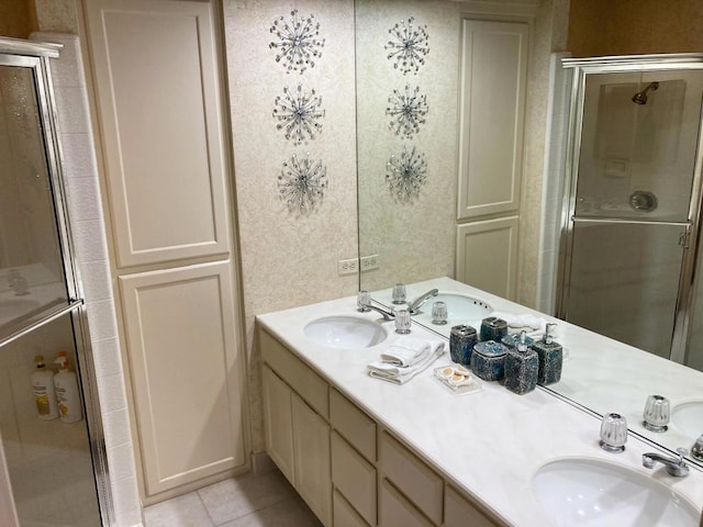 bathroom featuring vanity, a shower with door, and tile patterned floors