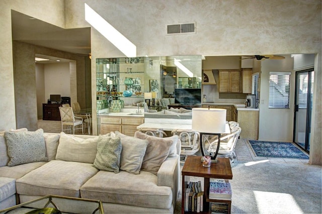 living room with ceiling fan and carpet