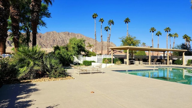 view of swimming pool with a mountain view and a patio area