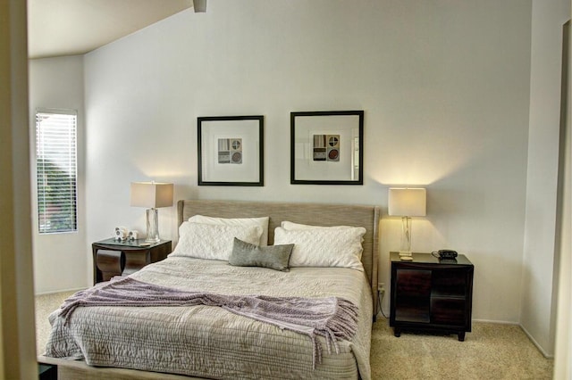 carpeted bedroom featuring lofted ceiling with beams