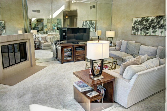 living room with light colored carpet and a towering ceiling