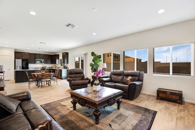 living room with light hardwood / wood-style flooring