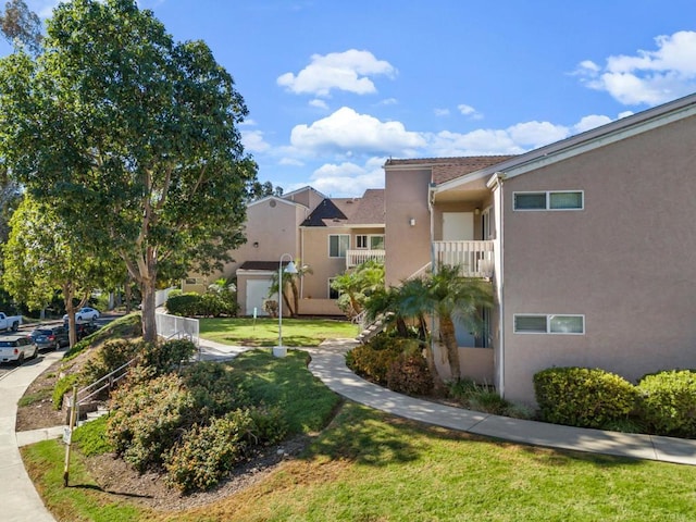 view of home's community featuring a lawn