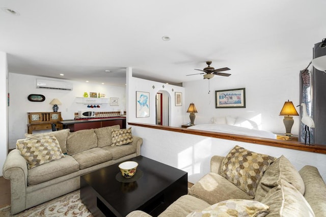 living room featuring ceiling fan and a wall mounted AC