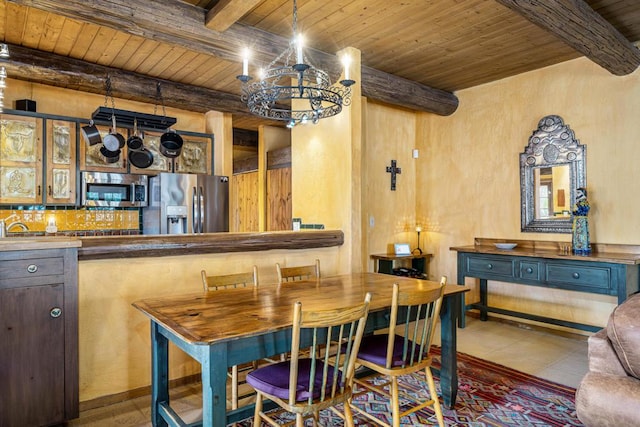 tiled dining room with beamed ceiling, a chandelier, and wooden ceiling