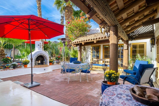 view of patio / terrace featuring exterior fireplace