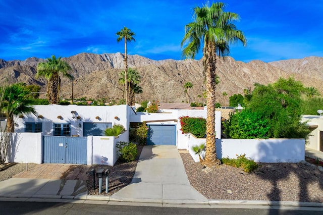 view of front of property with a mountain view and a garage