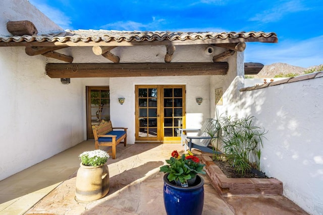 view of patio / terrace with a mountain view and french doors