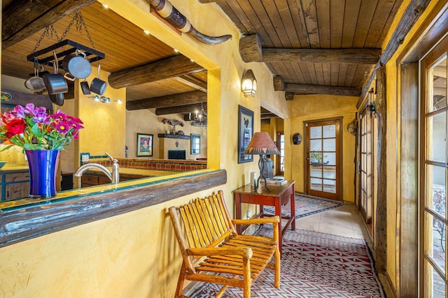 bar with tile patterned floors, vaulted ceiling with beams, and wooden ceiling