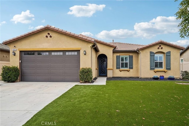 14443 Bottlebrush Way, Moreno Valley, CA 92555 - mediterranean / spanish home with an attached garage, a front lawn, concrete driveway, a tile roof, and stucco siding