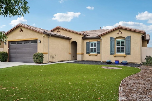 mediterranean / spanish-style house featuring a garage and a front lawn