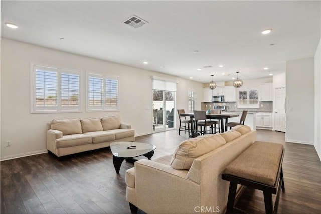 14443 Bottlebrush Way, Moreno Valley, CA 92555 - living area featuring baseboards, dark wood-style floors, and recessed lighting