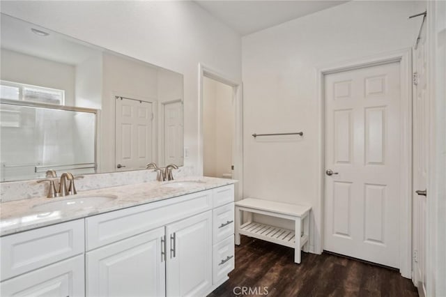 bathroom featuring walk in shower, vanity, and hardwood / wood-style flooring