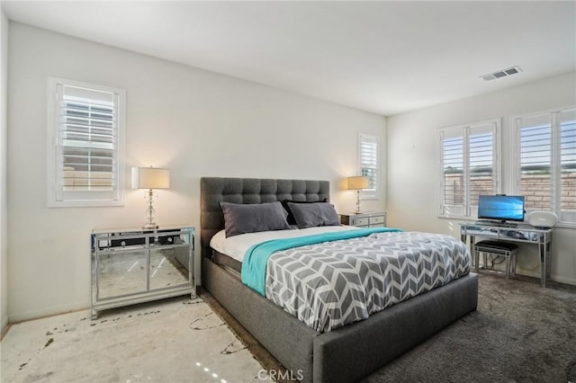 carpeted bedroom featuring multiple windows