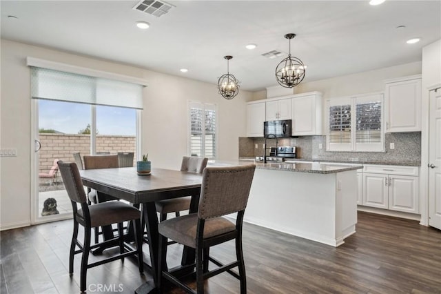 dining room featuring a chandelier and dark hardwood / wood-style flooring