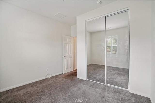 unfurnished bedroom with carpet flooring and a closet