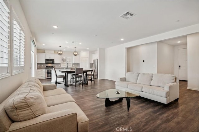 living room with dark hardwood / wood-style floors