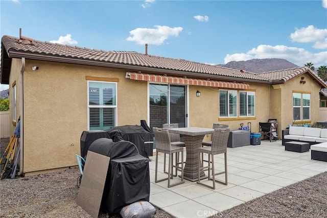 back of house featuring an outdoor living space and a patio