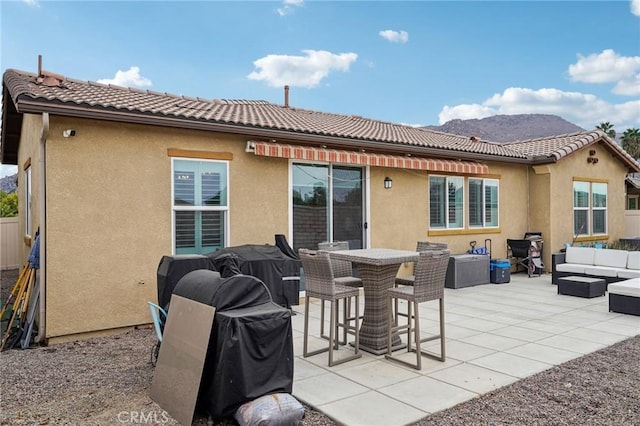 14443 Bottlebrush Way, Moreno Valley, CA 92555 - rear view of house featuring an outdoor hangout area, a tile roof, a patio, and stucco siding